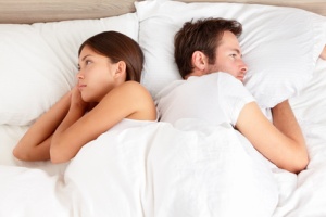 Upset couple with marital problems in bed